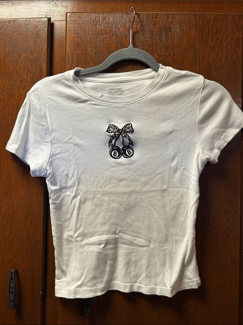 White Baby Tee with Embroidered Black Cherry 8-Ball Patch